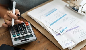 how to run a clinic successfully - calculator and invoices on desk