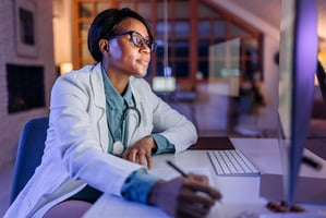 Doctor working on a computer. Article about EHR implementation