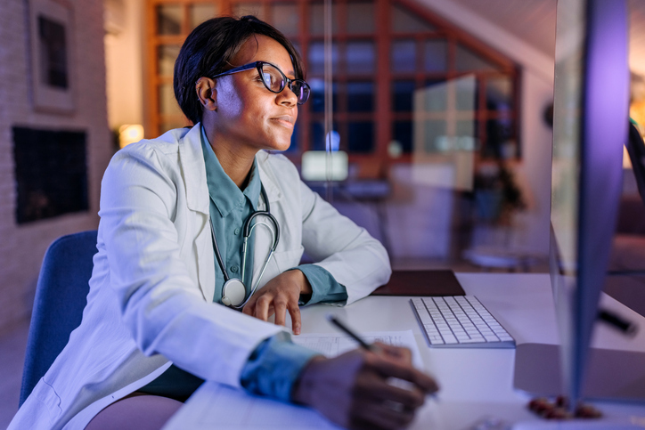 Doctor working on a computer. Article about EHR implementation
