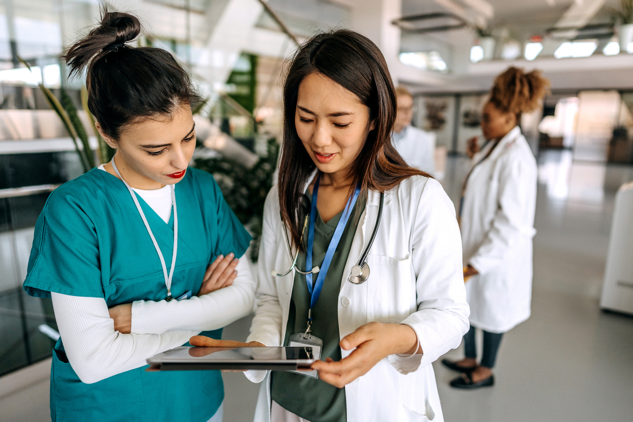 Doctors consulting. Article discusses the ultimate physician credentialing checklist.